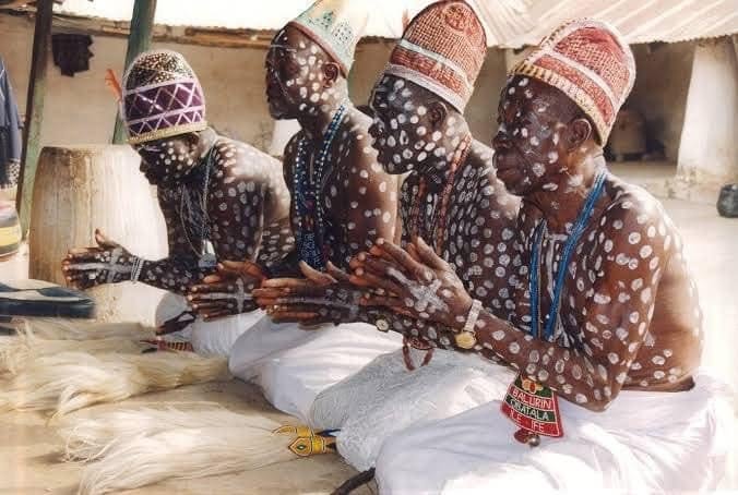Four Obàtálá elders with sacred white body markings seated in prayer