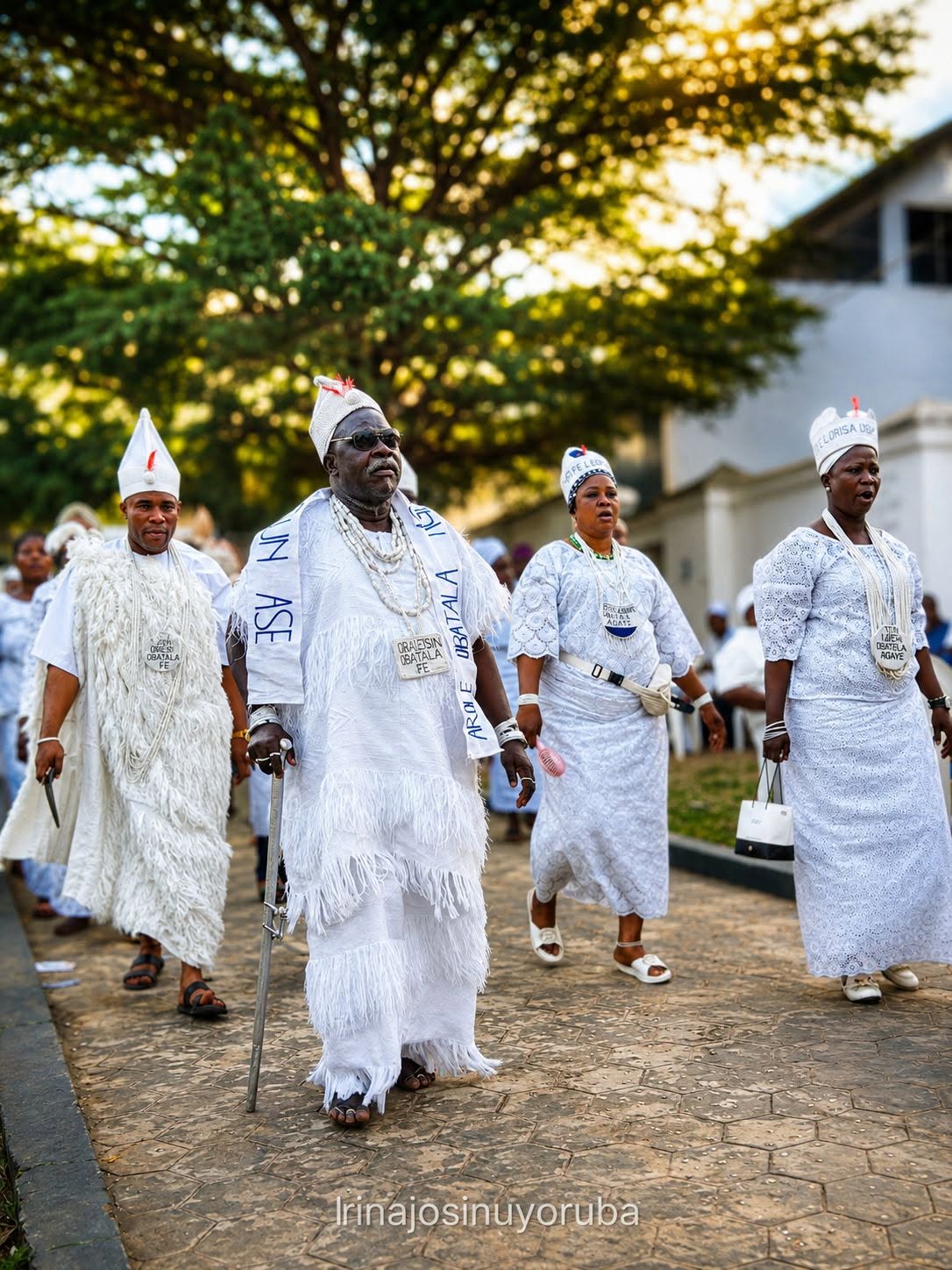 Obàtálá priests and priestesses in white ceremonial dress walking in procession